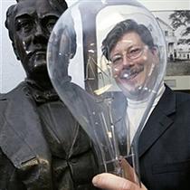 Jack Stanley, curator of the Edison Museum in Edison, N.J., holds a large light bulb next to a bust of inventor Thomas A. Edison at the museum Wednesday, Feb. 7, 2007.